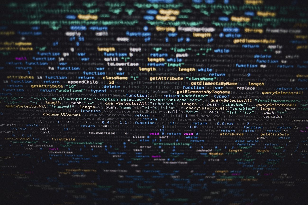 Software developer programming code on black